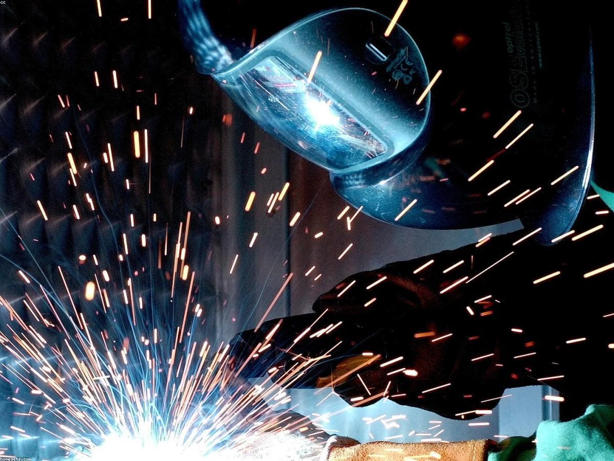 A welder at work, sparks flying from the seam